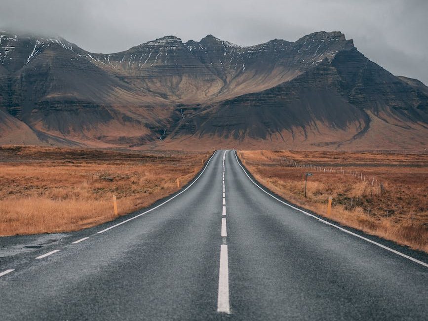 empty highway overlooking mountain under dark skies